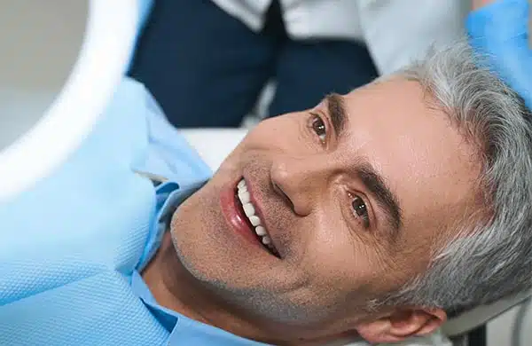 Smiling man in dental chair during examination at Brighton Healthy Smiles clinic