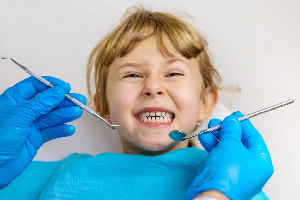 A young patient smiles during a routine dental visit, highlighting how preventive dentistry helps protect children's teeth, promote healthy oral habits, and reduce the risk of future dental problems.