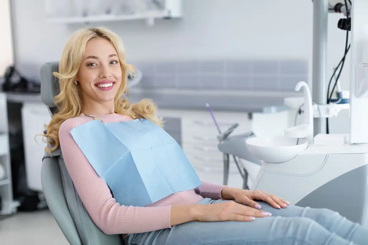A patient receives a routine dental examination, emphasizing the importance of regular cleanings and checkups to maintain healthy teeth and gums for the whole family.